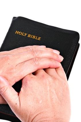 64876-283x424-Hands Over Bible